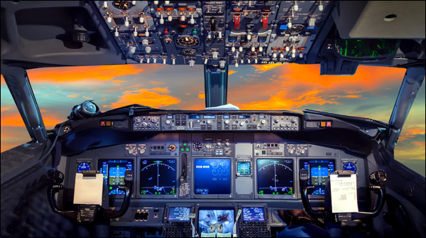 Image of cockpit flight deck at sunset