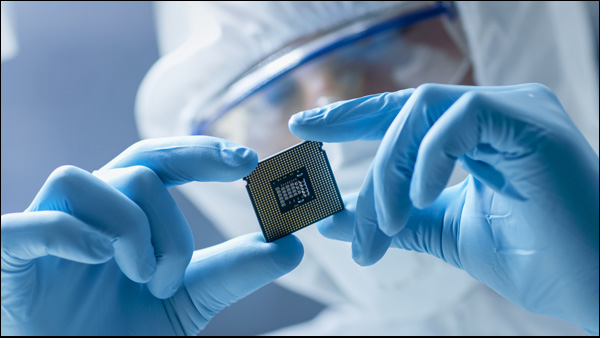 Image of engineer holding microchip