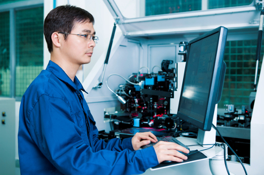 Worker operating a CNC machine